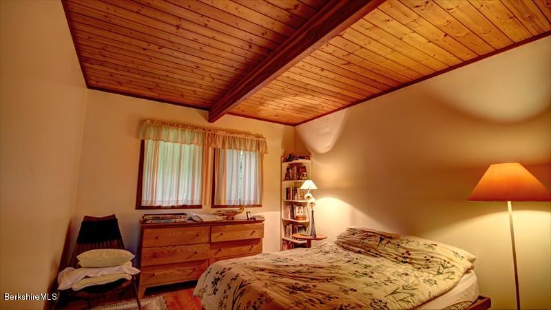 517 Dimmock Road Otis, MA 01253 - Photo 17 of 21 a bedroom with furniture and a chair