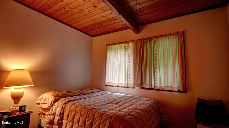 517 Dimmock Road Otis, MA 01253 - Photo 18 of 21 a bedroom with a bed and a lamp
