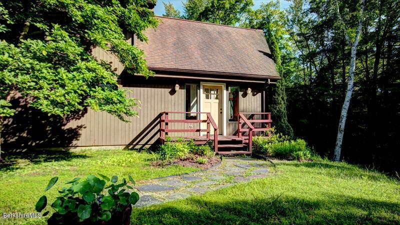 517 Dimmock Road Otis, MA 01253 - Photo 3 of 21 a backyard of a house with plants and a tree