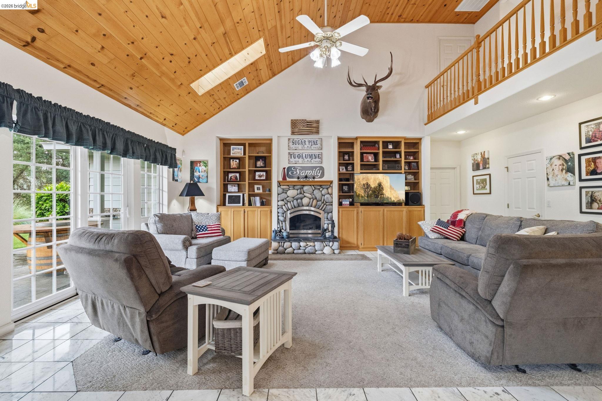 18450 Lambert Lake Road Sonora, CA 95370 - Photo 35 of 87 Vaulted wood-paneled ceiling with skylight and ceiling fan