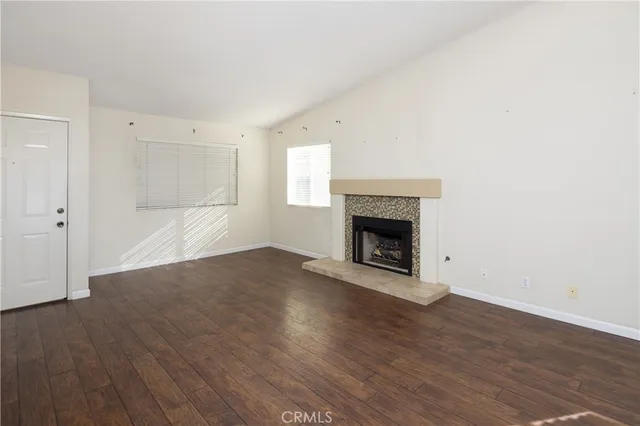 a view of a room with wooden floor and white walls