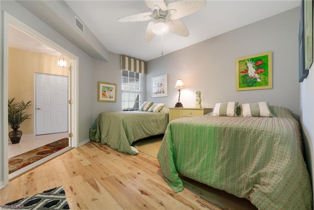 23770 Clear Spring Court, Unit 1408 Estero, FL 34135 - Photo 18 of 33 a bedroom with a bed and a chandelier