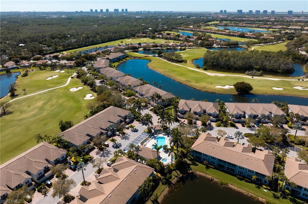 23770 Clear Spring Court, Unit 1408 Estero, FL 34135 - Photo 25 of 33 an aerial view of a city with lots of residential buildings ocean and mountain view
