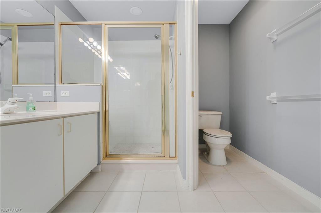 23770 Clear Spring Court, Unit 1408 Estero, FL 34135 - Photo 6 of 33 a spacious bathroom with a toilet sink and a mirror