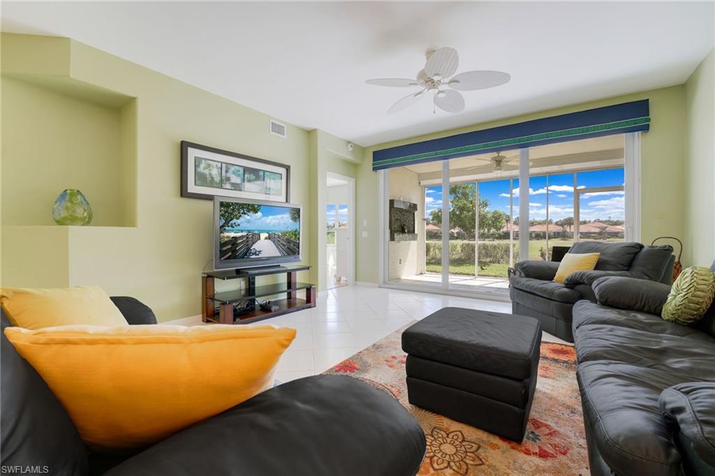 23770 Clear Spring Court, Unit 1408 Estero, FL 34135 - Photo 9 of 33 a living room with furniture and a large window