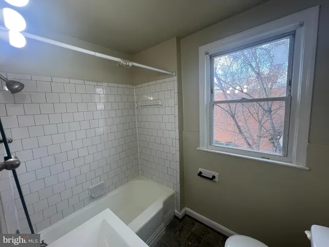 a bathroom with a bathtub and window
