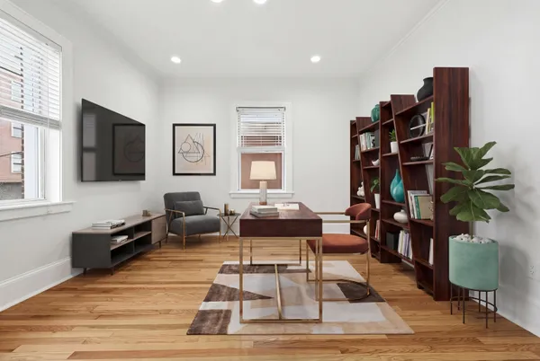 a living room with furniture a flat screen tv and a table