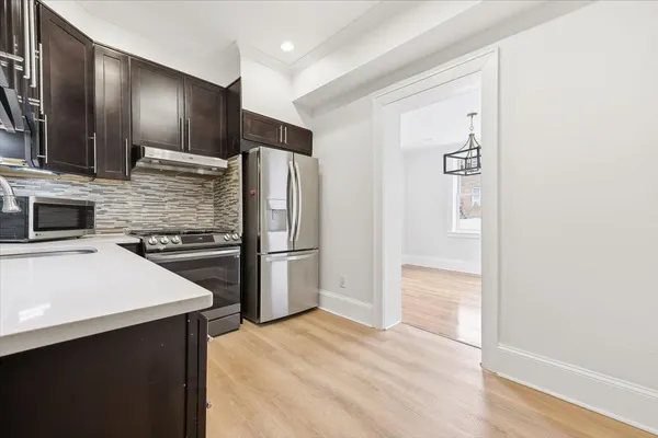 a kitchen with stainless steel appliances a refrigerator and a stove