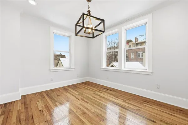 a view of a room with wooden floor cabinet and windows