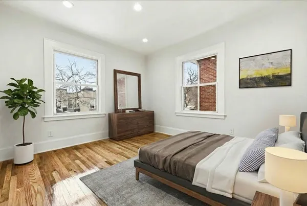 a bedroom with a large bed and a window