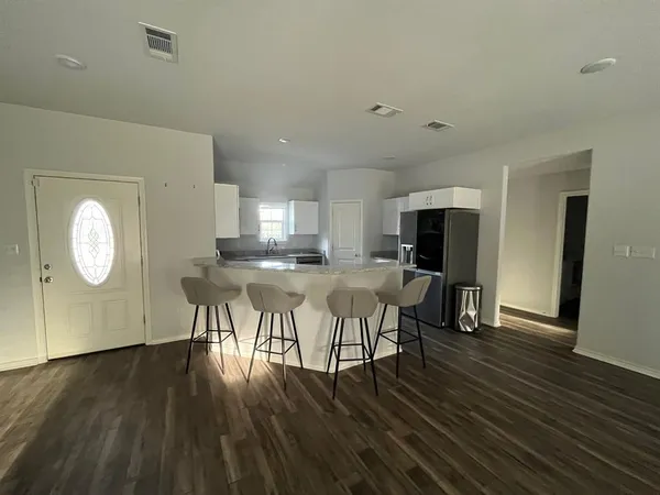 a view of a dining room with furniture and wooden floor