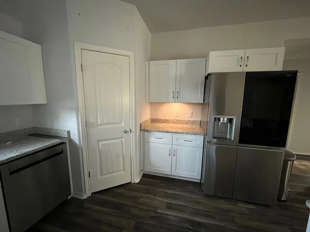 a kitchen with appliances and cabinets