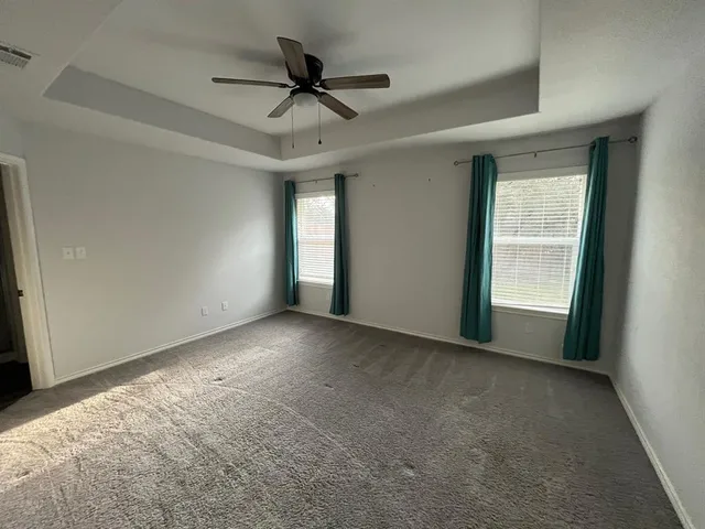 a view of a livingroom with a ceiling fan and window