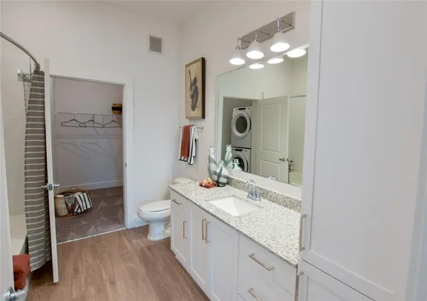 a bathroom with a sink vanity granite and a toilet