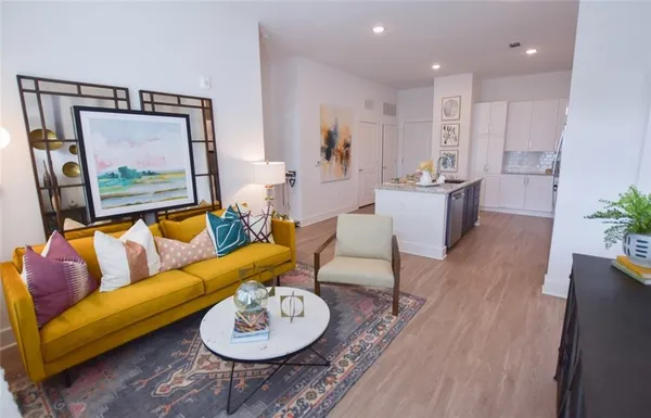 a living room with furniture and a wooden floor