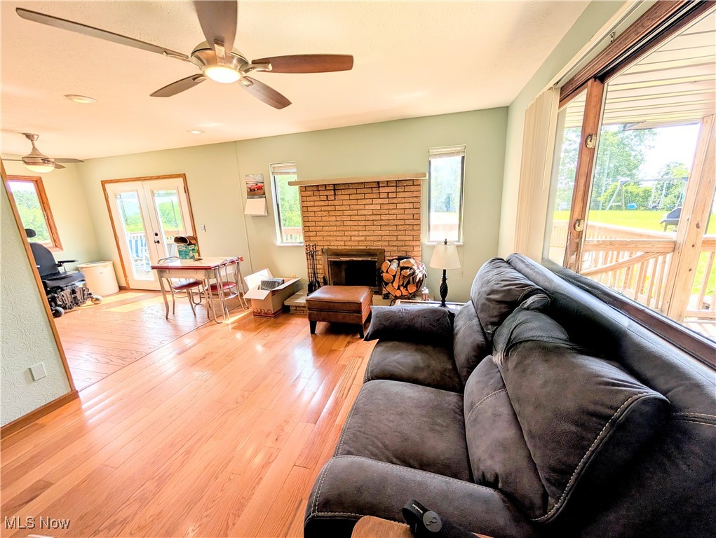 77 Morgan Ridge Road Walker, WV 26180 - Photo 15 of 30 Living room featuring light wood-style flooring, a ceiling fan, a fireplace, and recessed lighting