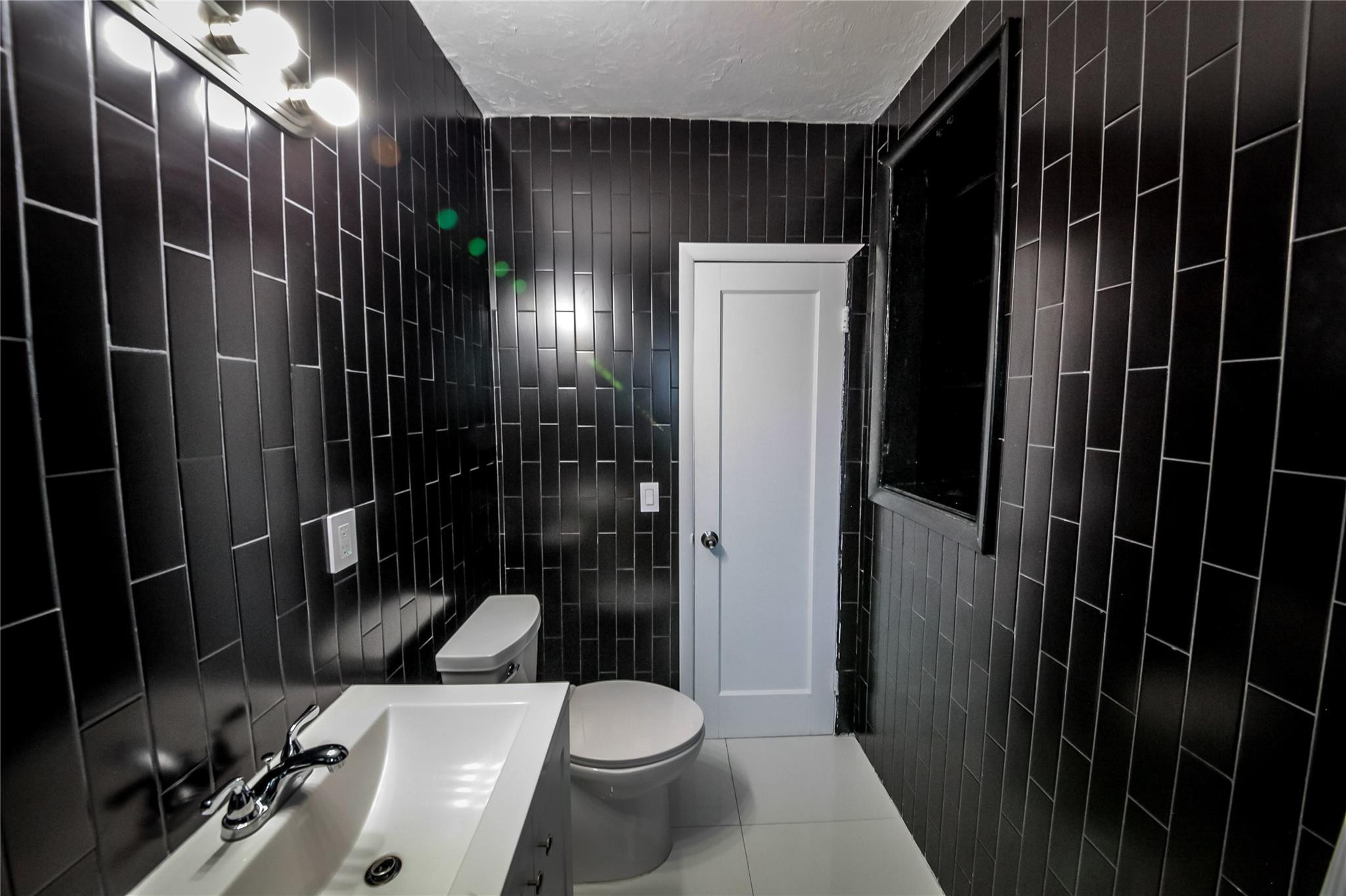 2221 Southwest 13th Street Miami, FL 33145 - Photo 11 of 24 a bathroom with a toilet a sink and shower