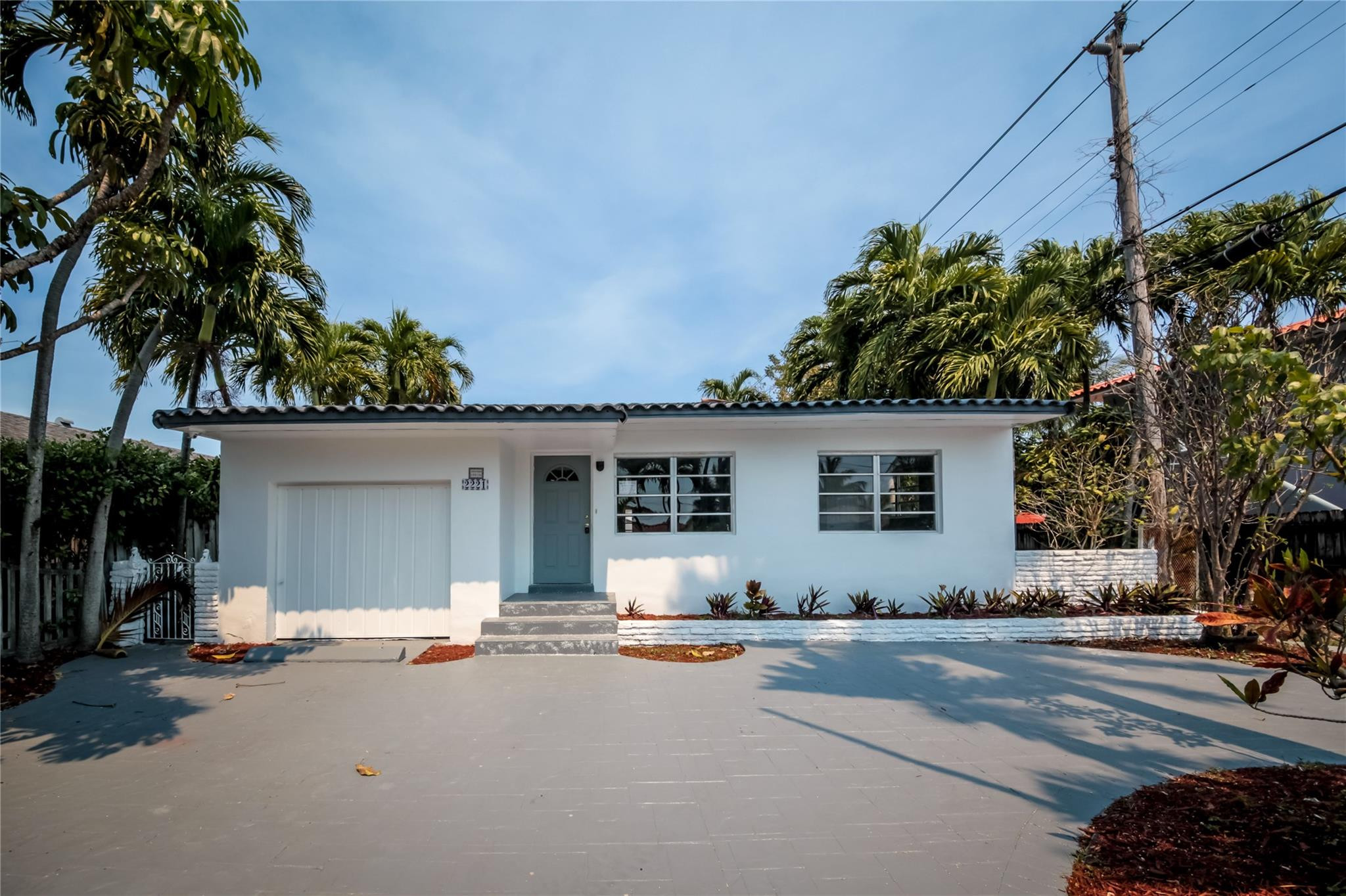 2221 Southwest 13th Street Miami, FL 33145 - Photo 2 of 24 a front view of a house with a yard and garage