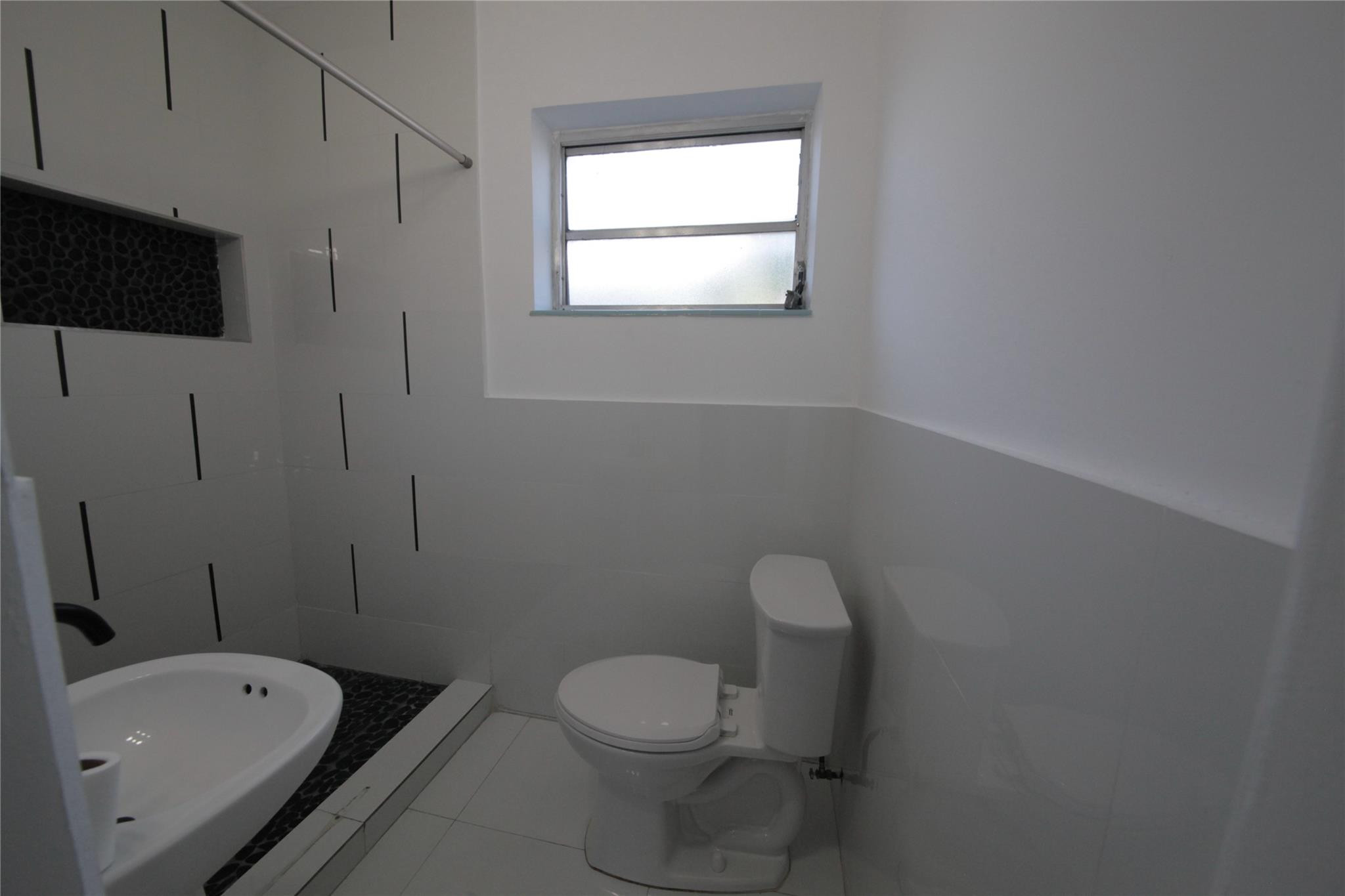 2221 Southwest 13th Street Miami, FL 33145 - Photo 23 of 24 a bathroom with a toilet a sink and bathtub
