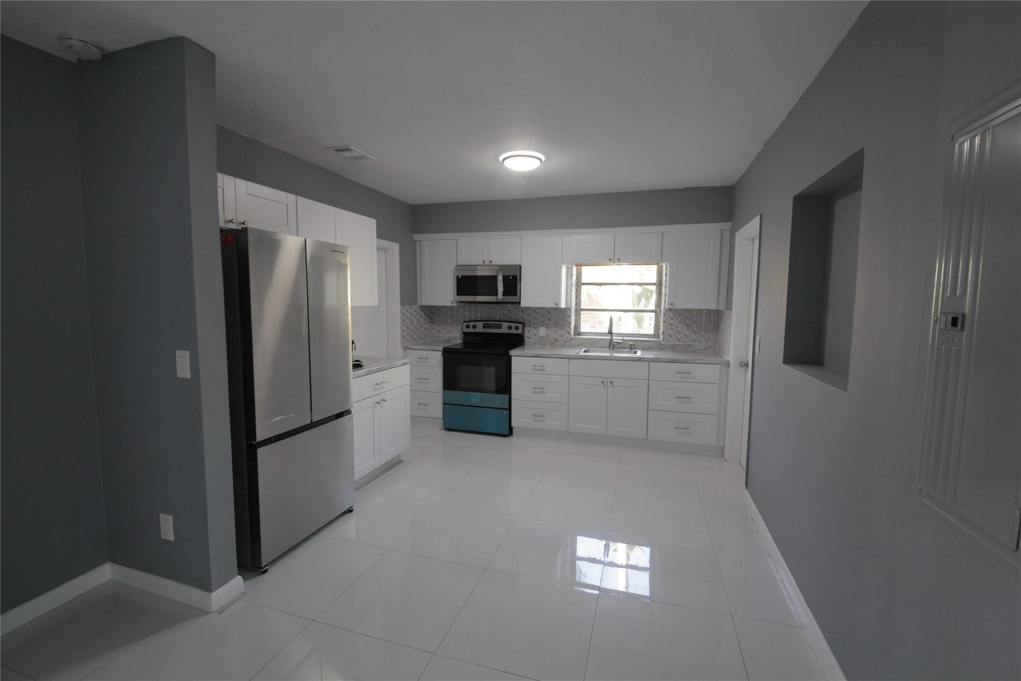 2221 Southwest 13th Street Miami, FL 33145 - Photo 5 of 24 a kitchen with stainless steel appliances granite countertop a refrigerator a stove a sink and a microwave