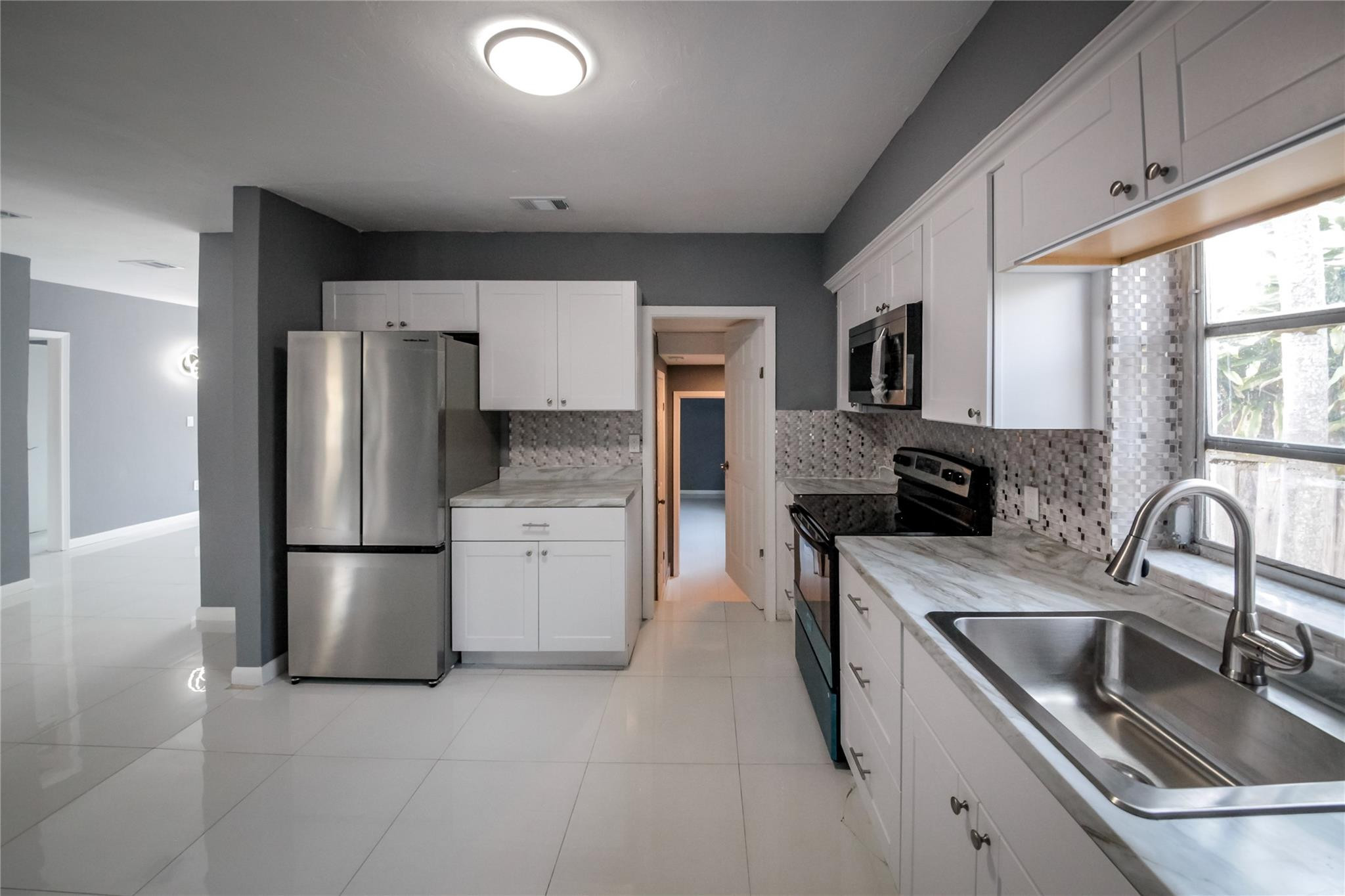 2221 Southwest 13th Street Miami, FL 33145 - Photo 6 of 24 a kitchen with a sink cabinets and stainless steel appliances