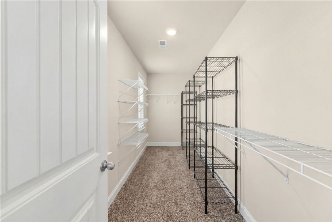 874 Wild Orchard Lane Woodruff, SC 29388 - Photo 12 of 35 This spacious closet offers ample storage with versatile shelving for optimal organization.