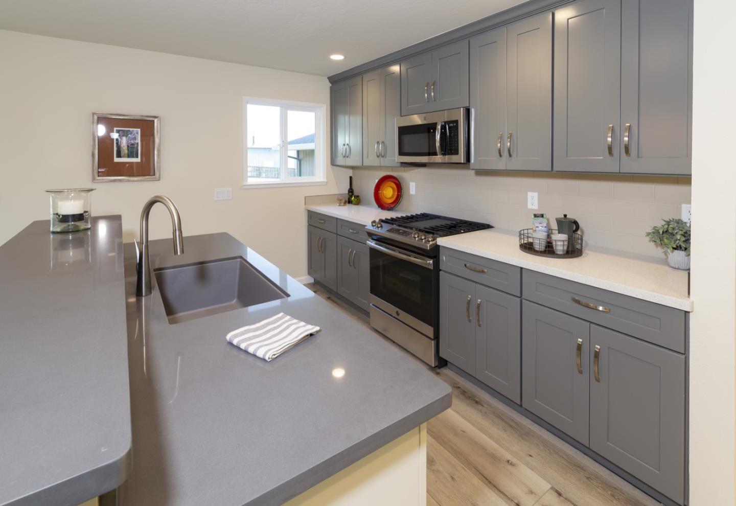 134 Hughes Road Watsonville, CA 95076 - Photo 6 of 26 a kitchen with stainless steel appliances granite countertop a sink stove and microwave