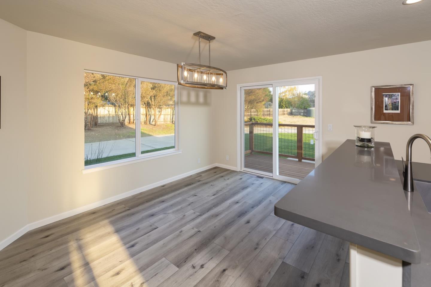 134 Hughes Road Watsonville, CA 95076 - Photo 7 of 26 a view of a room with wooden floor wooden floor and windows