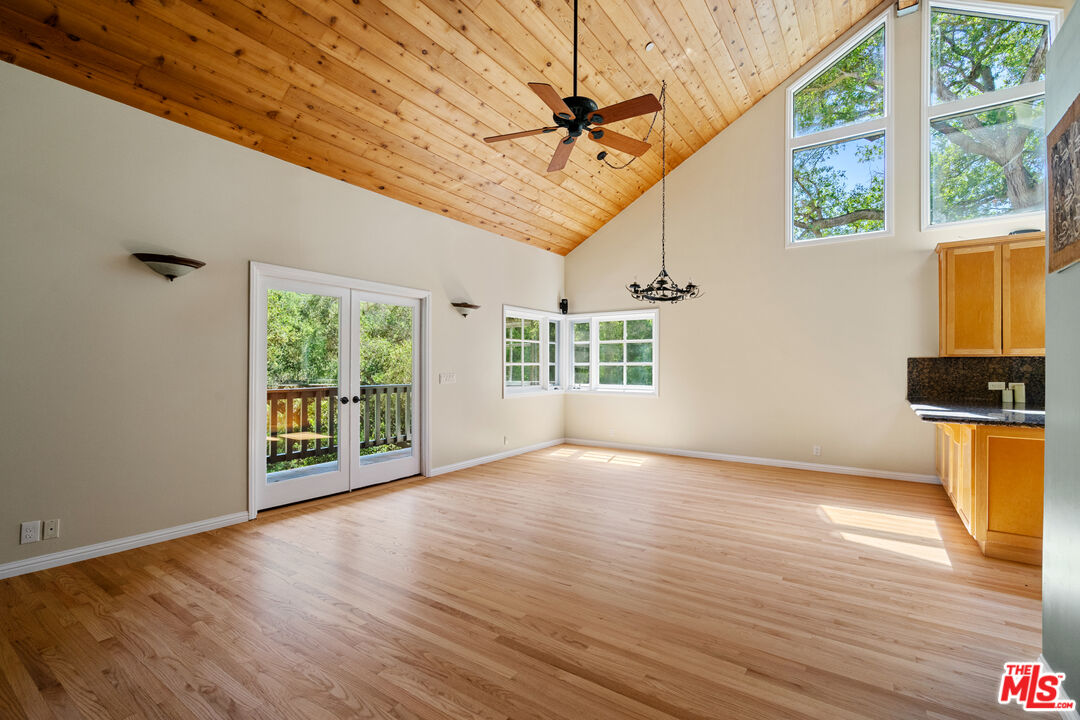 20912 Fontaine Road Topanga, CA 90290 - Photo 15 of 52 a view of an empty room with wooden floor and a window