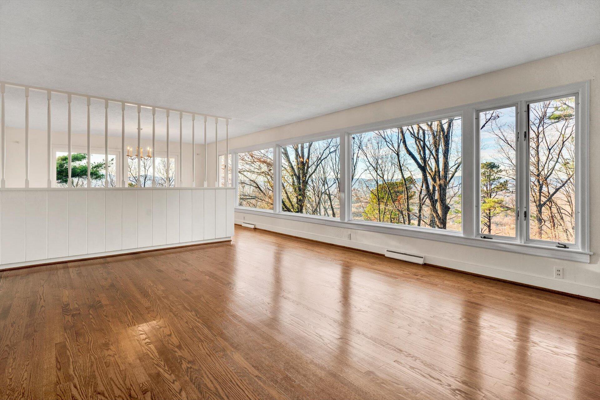 3442 West Ridge Road Southwest Roanoke, VA 24014 - Photo 7 of 42 a view of an empty room with wooden floor and a window