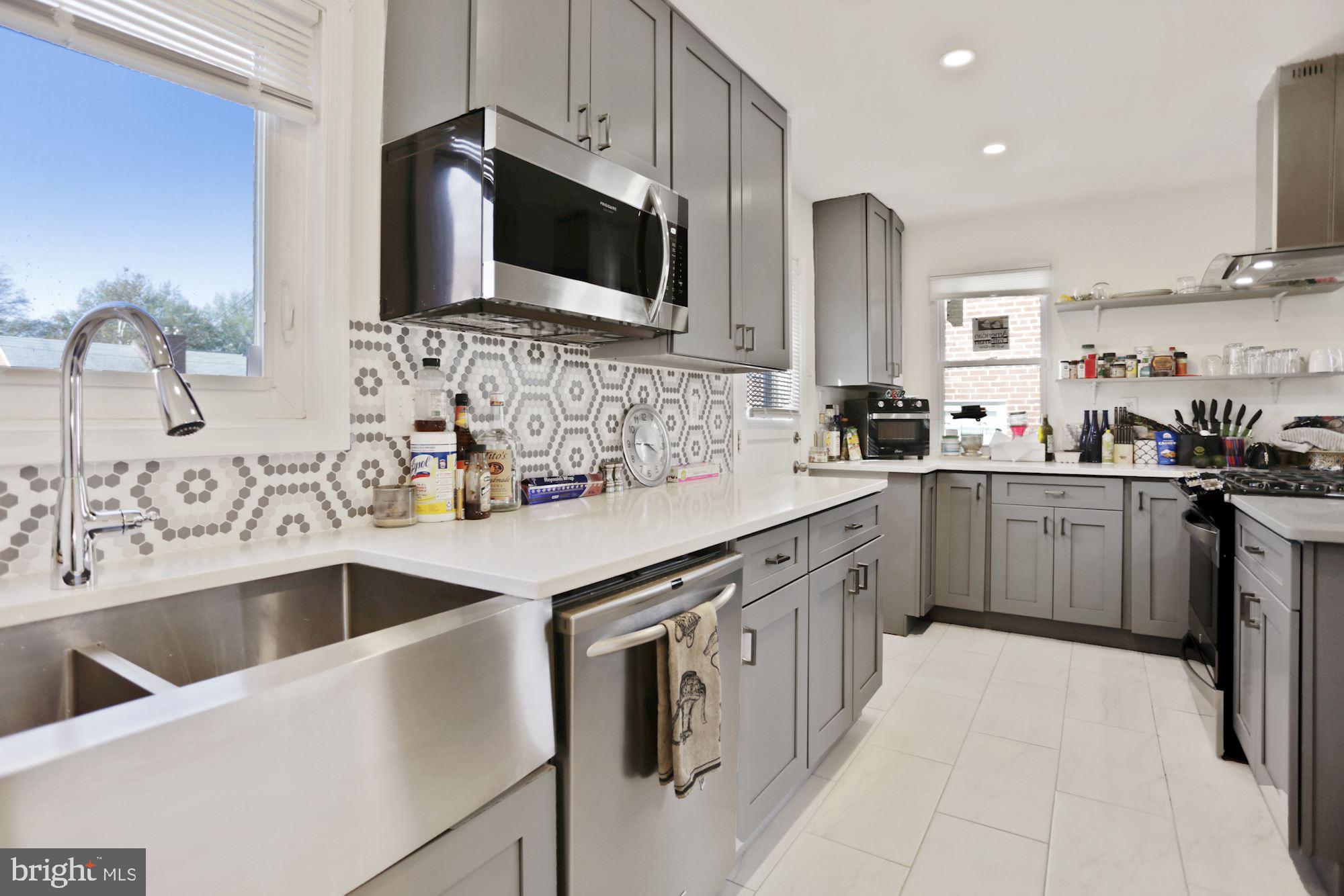 4910 Sargent Road Northeast Washington, DC 20017 - Photo 2 of 16 a kitchen that has a sink and a stove