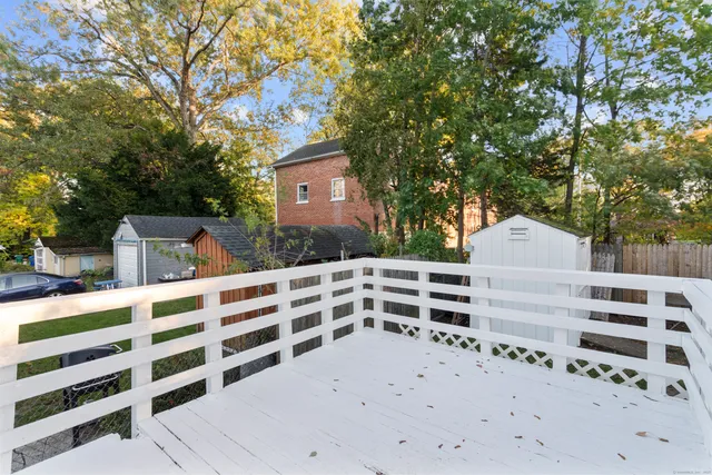 a view of a wooden house and a yard