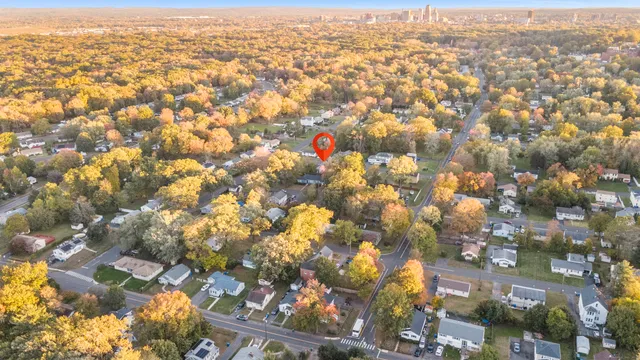 an aerial view of residential houses with city view
