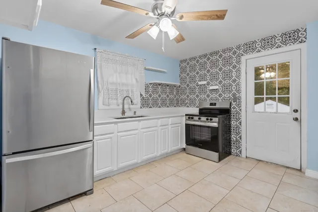 a kitchen with a stove sink and refrigerator