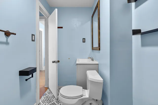 a white toilet sitting next to a bathroom sink