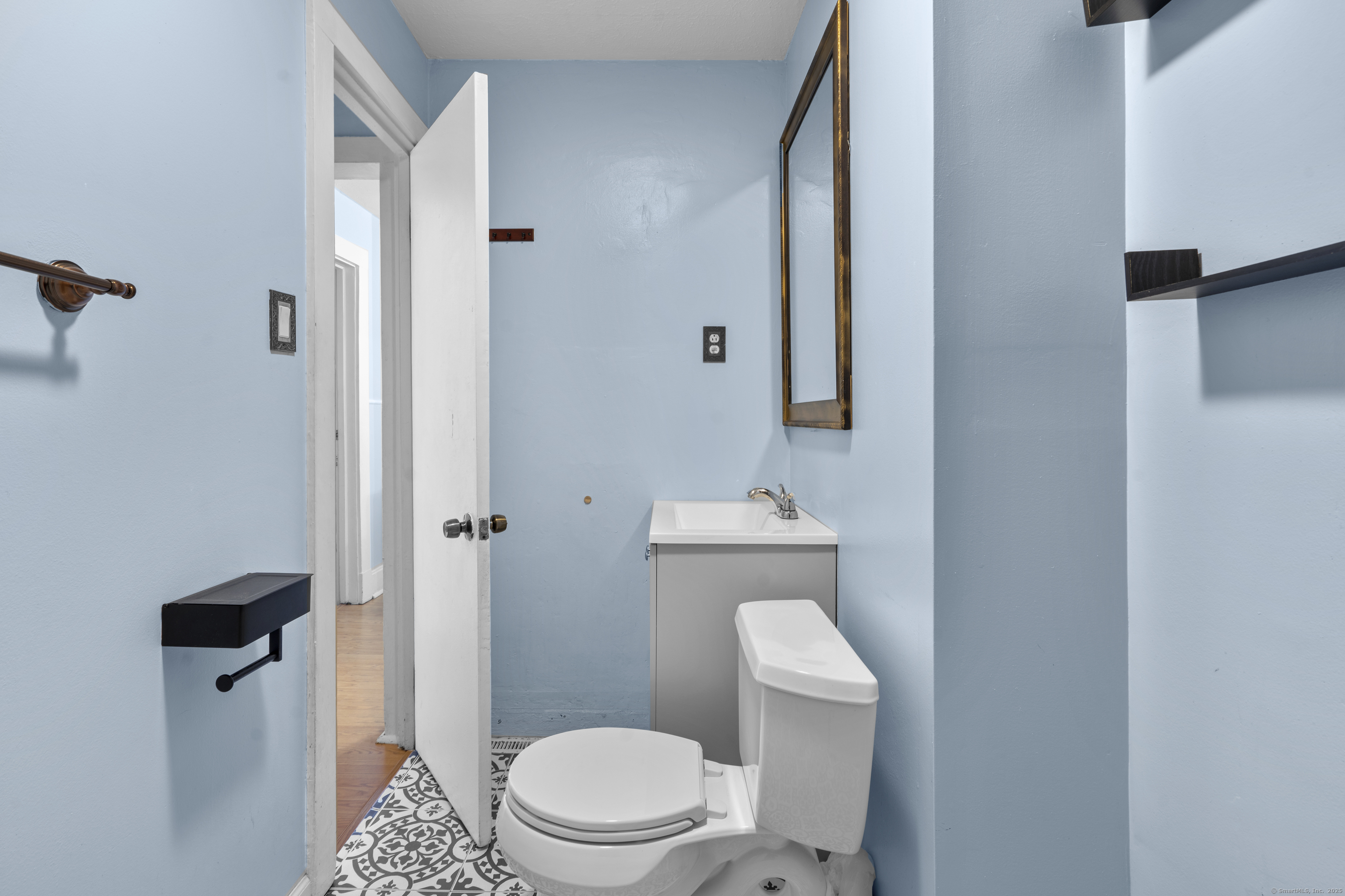 67 Elizabeth Avenue Bloomfield, CT 06002 - Photo 6 of 20 a white toilet sitting next to a bathroom sink