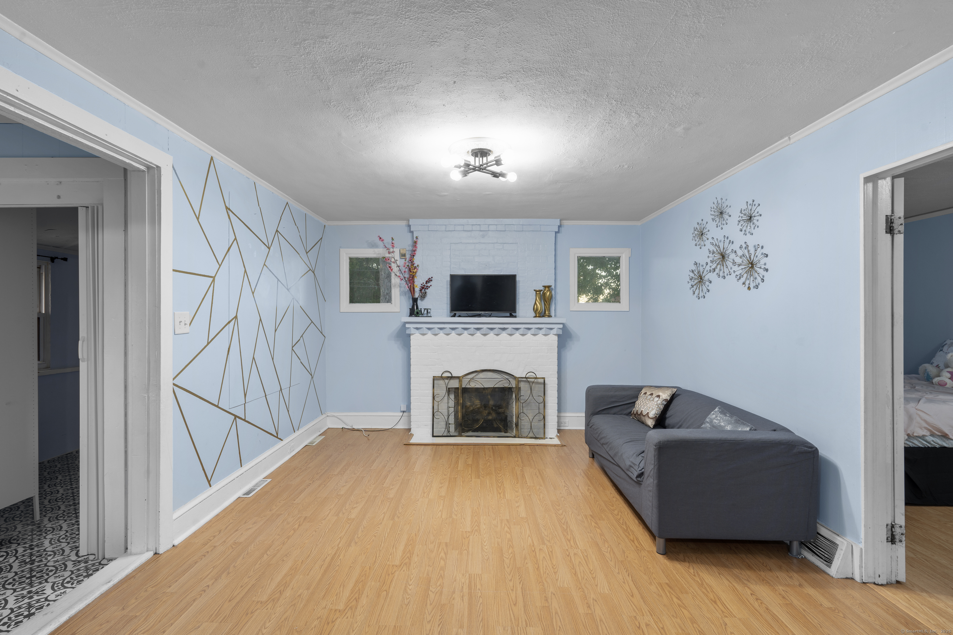 67 Elizabeth Avenue Bloomfield, CT 06002 - Photo 7 of 20 a living room with furniture and a fireplace