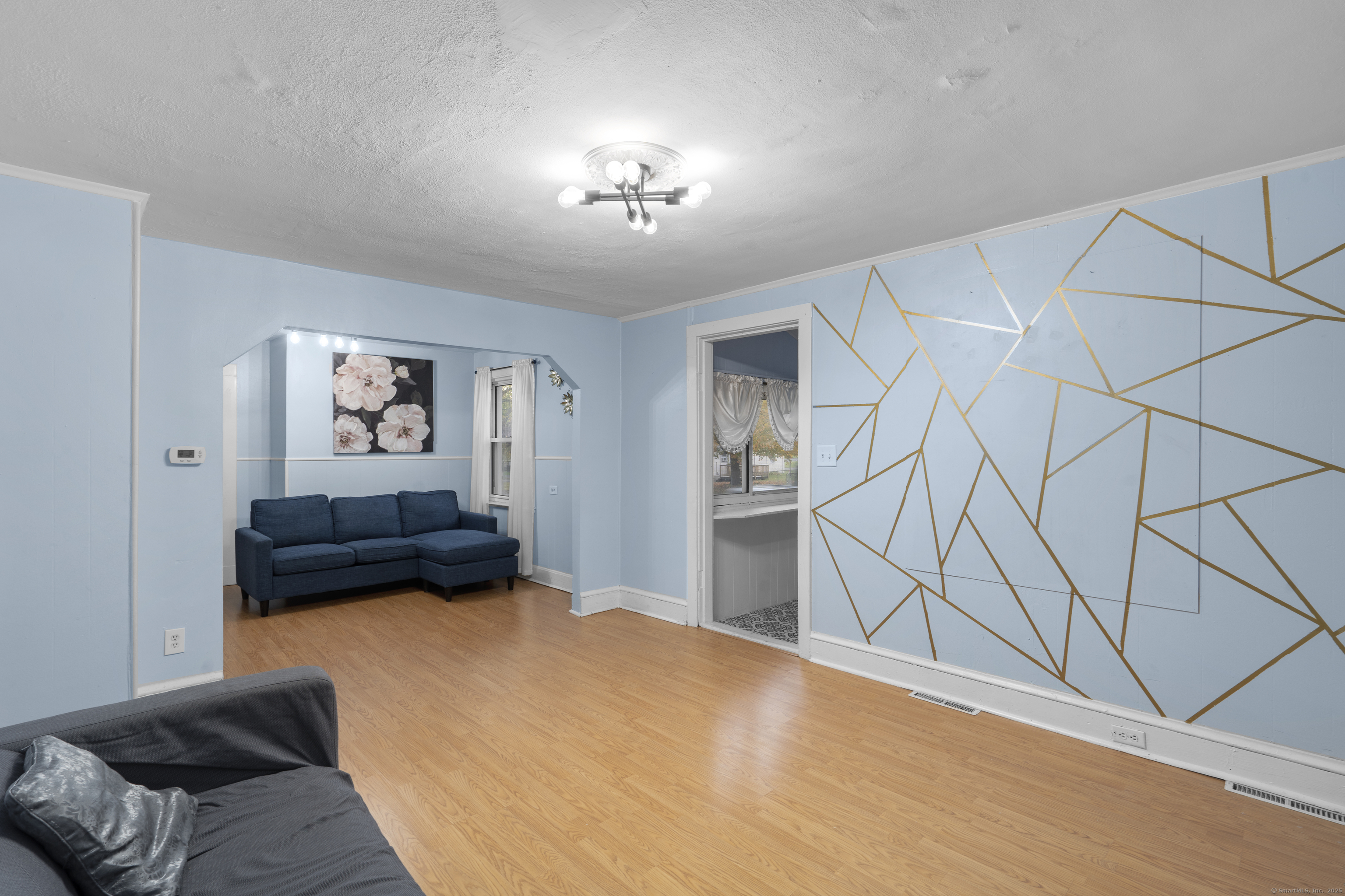 67 Elizabeth Avenue Bloomfield, CT 06002 - Photo 8 of 20 a bedroom with a bed and a chandelier