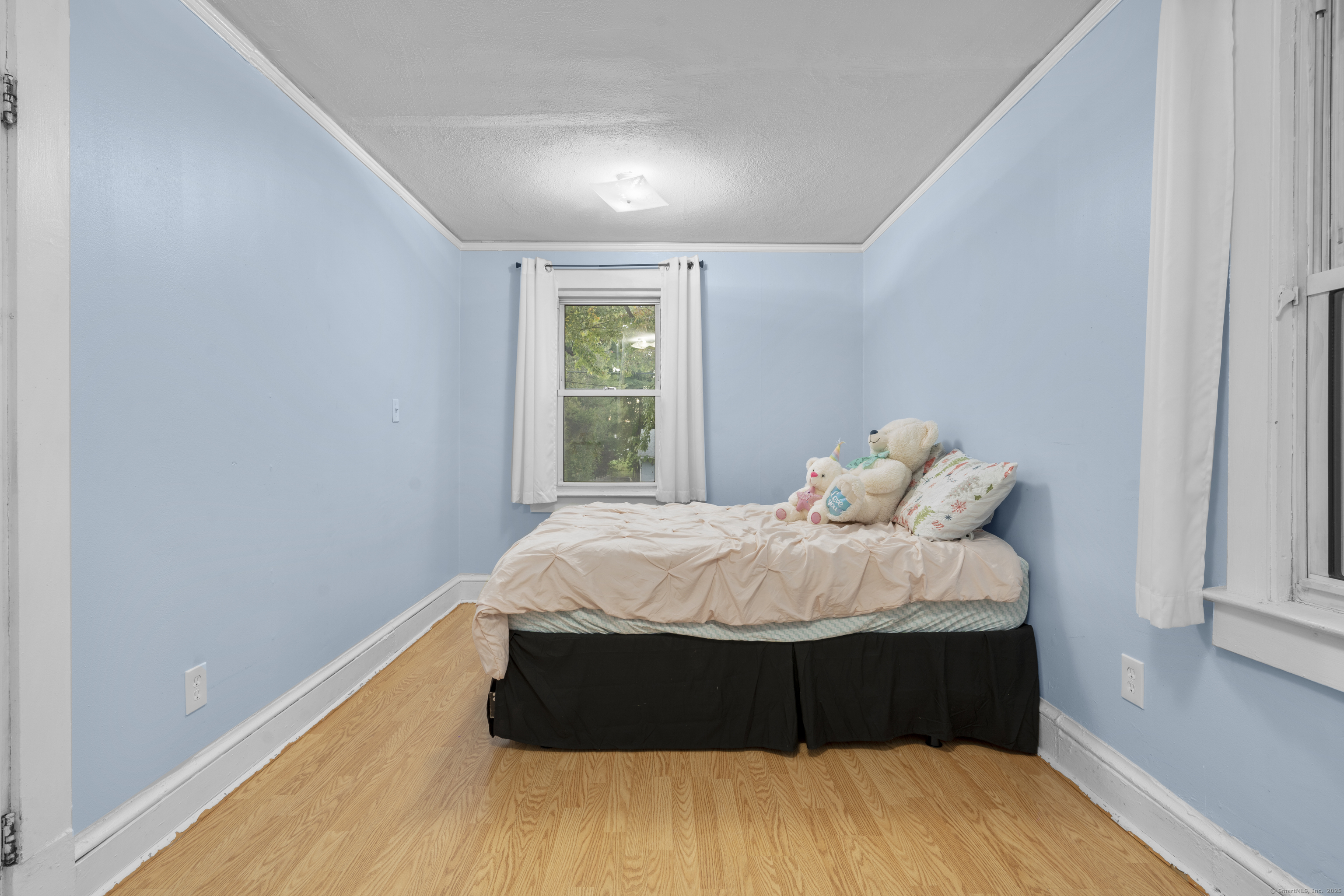 67 Elizabeth Avenue Bloomfield, CT 06002 - Photo 9 of 20 a bed sitting in a bedroom next to a window