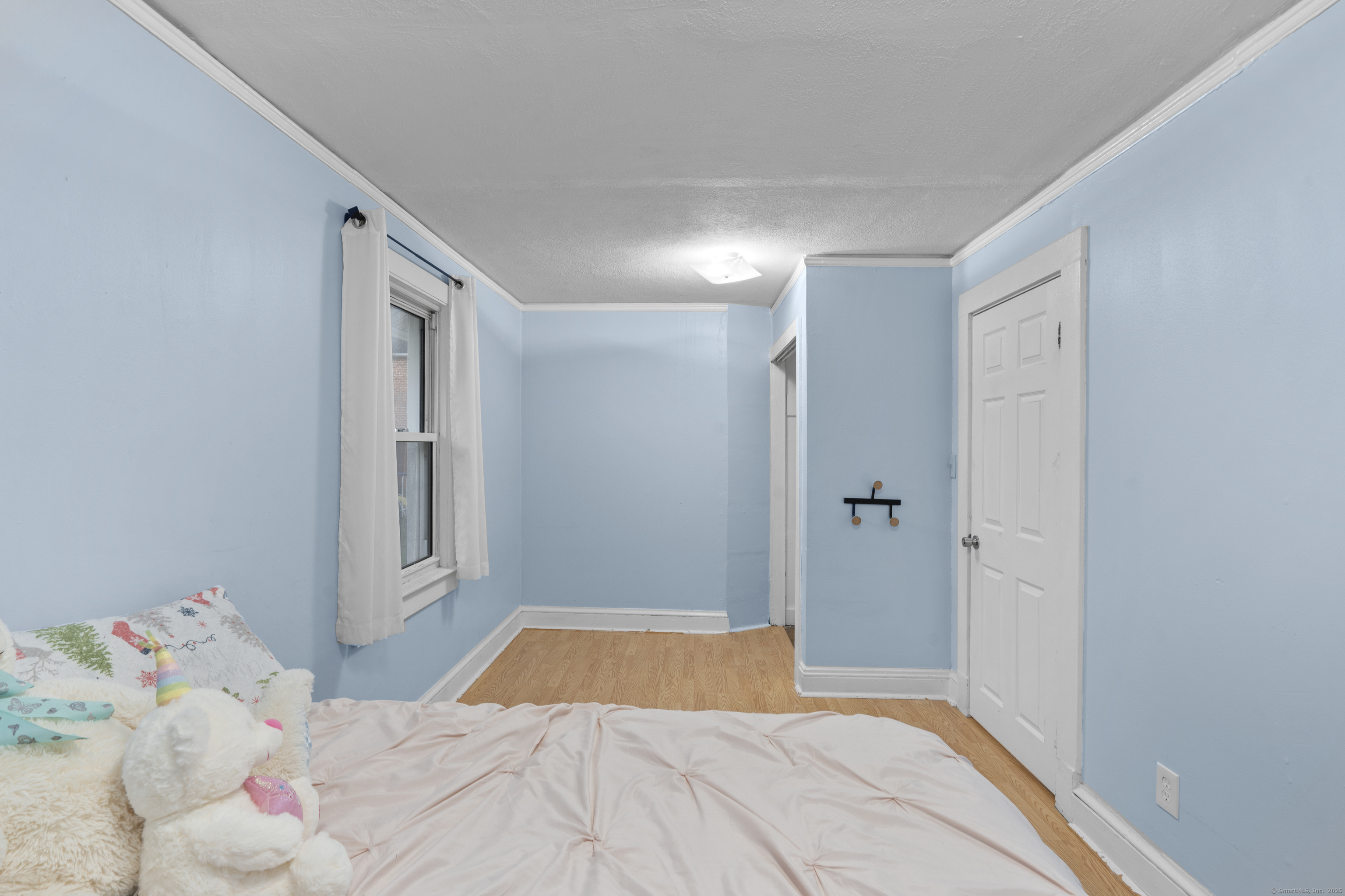 67 Elizabeth Avenue Bloomfield, CT 06002 - Photo 10 of 20 a bedroom with a bed and a window