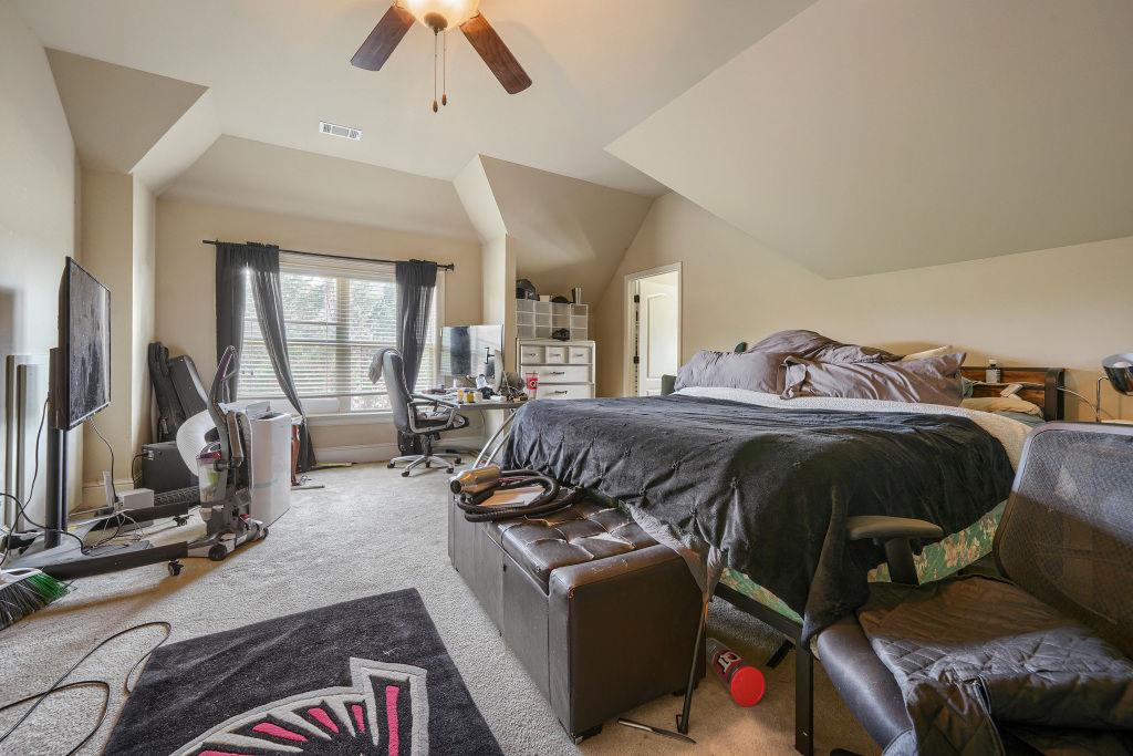 345 Masters Club Boulevard Hampton, GA 30228 - Photo 23 of 30 a bedroom with furniture and a flat screen tv