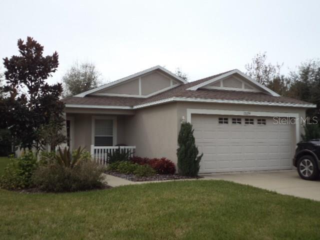 12039 Deertrack Loop Spring Hill, FL 34610 - Photo 1 of 1 a front view of a house with a garden and plants