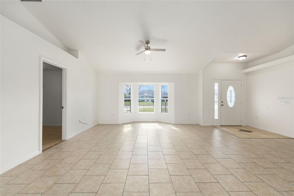 15434 Southwest 23rd Court Road Ocala, FL 34473 - Photo 9 of 41 an empty room with windows and fan