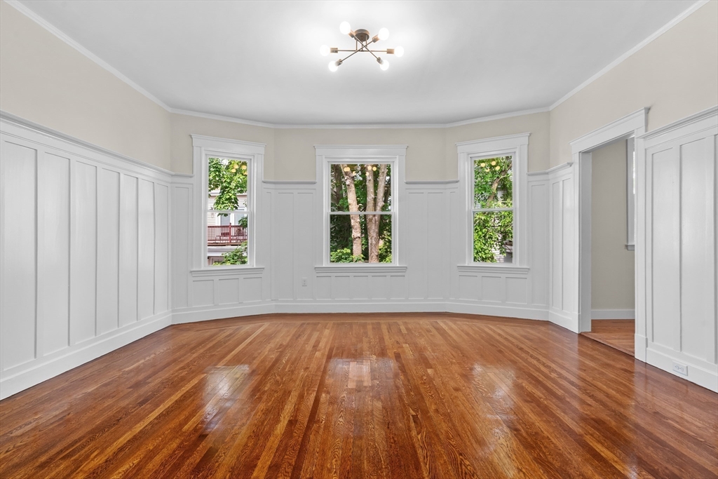35 George Street, Unit 35 Newton, MA 02458 - Photo 11 of 36 a view of an empty room with wooden floor and a window