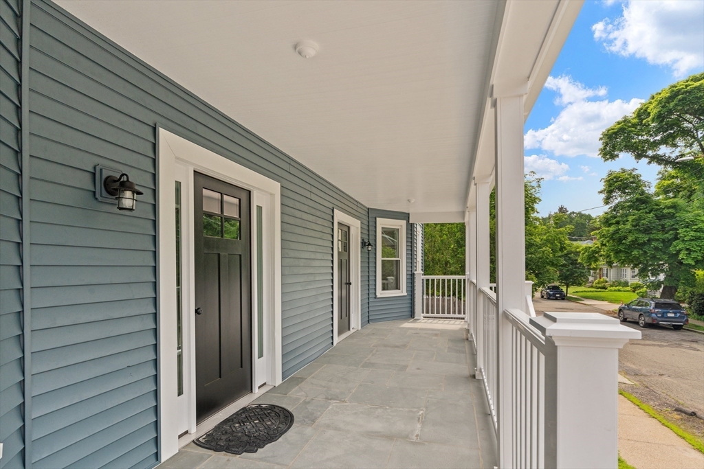 35 George Street, Unit 35 Newton, MA 02458 - Photo 14 of 36 a view of a house with porch and wooden fence