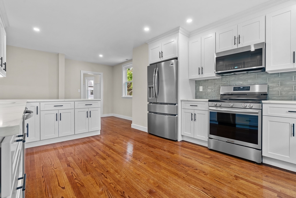 35 George Street, Unit 35 Newton, MA 02458 - Photo 15 of 36 a kitchen with white cabinets and stainless steel appliances