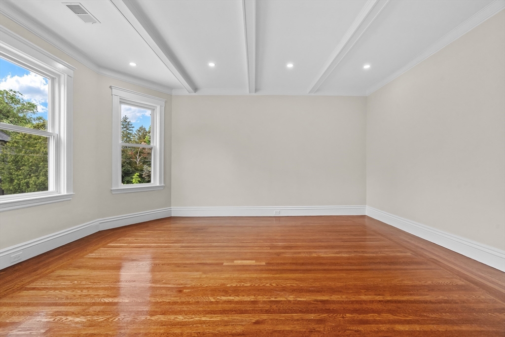 35 George Street, Unit 35 Newton, MA 02458 - Photo 17 of 36 a view of an empty room with wooden floor and a window
