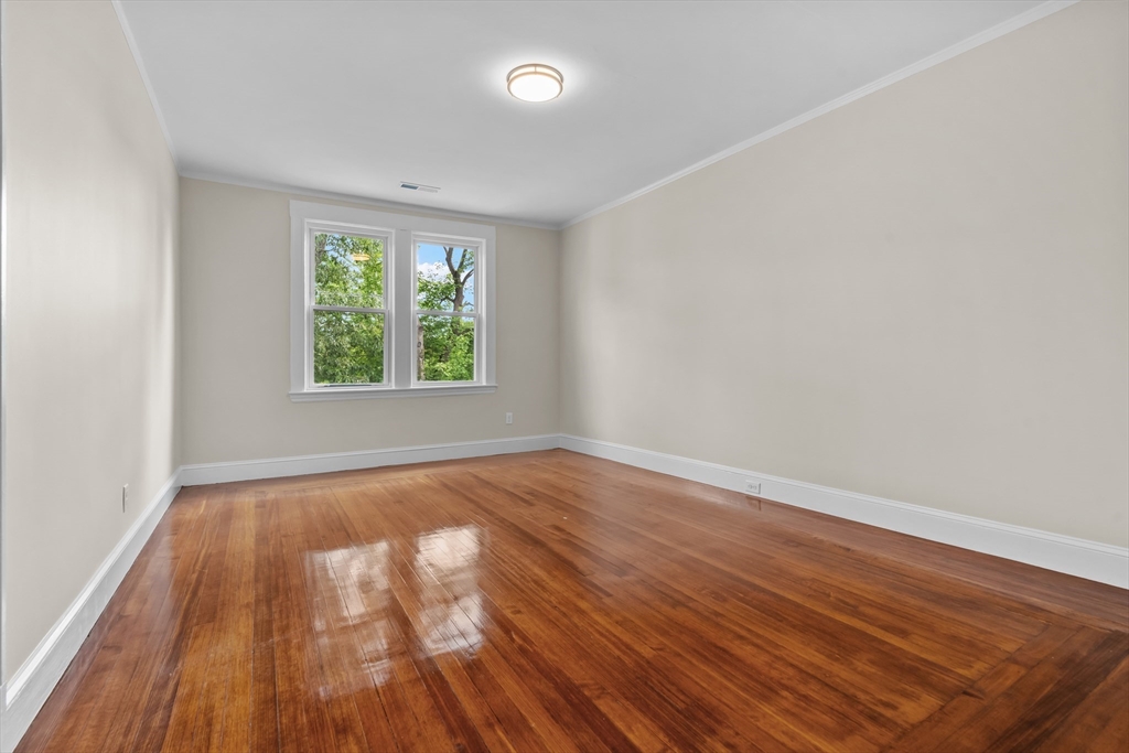 35 George Street, Unit 35 Newton, MA 02458 - Photo 19 of 36 wooden floor in an empty room with a window