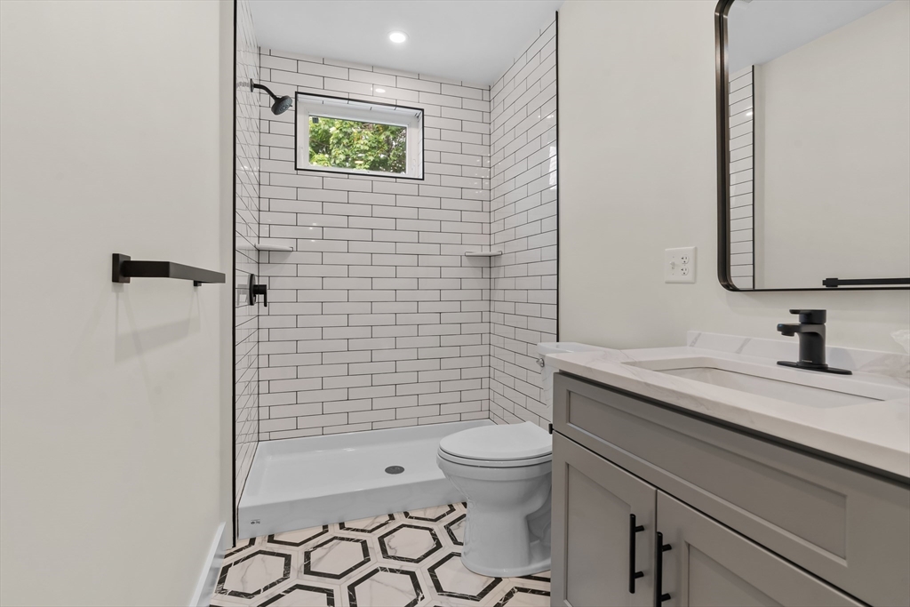 35 George Street, Unit 35 Newton, MA 02458 - Photo 20 of 36 a bathroom with a granite countertop toilet sink and shower