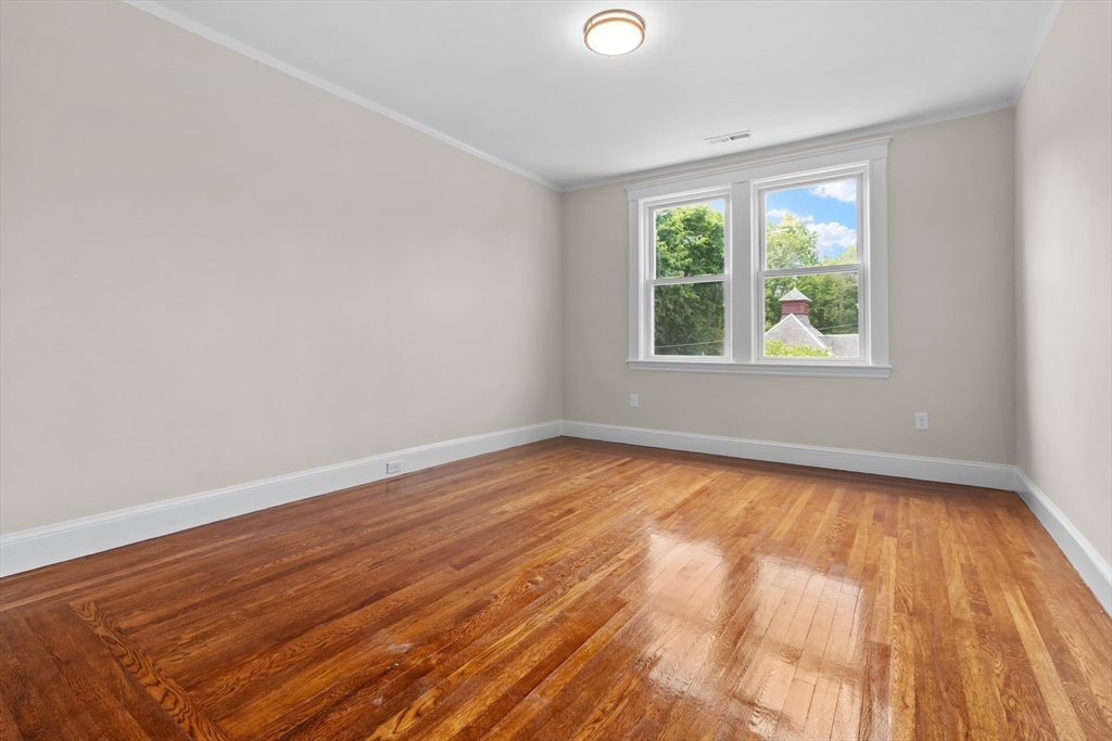 35 George Street, Unit 35 Newton, MA 02458 - Photo 23 of 36 an empty room with wooden floor and windows